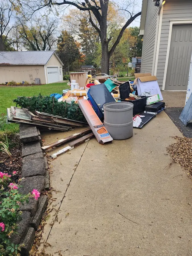 Dumpster being loaded with debris for 3 Yard Dumpster Rental in Cypress Lake